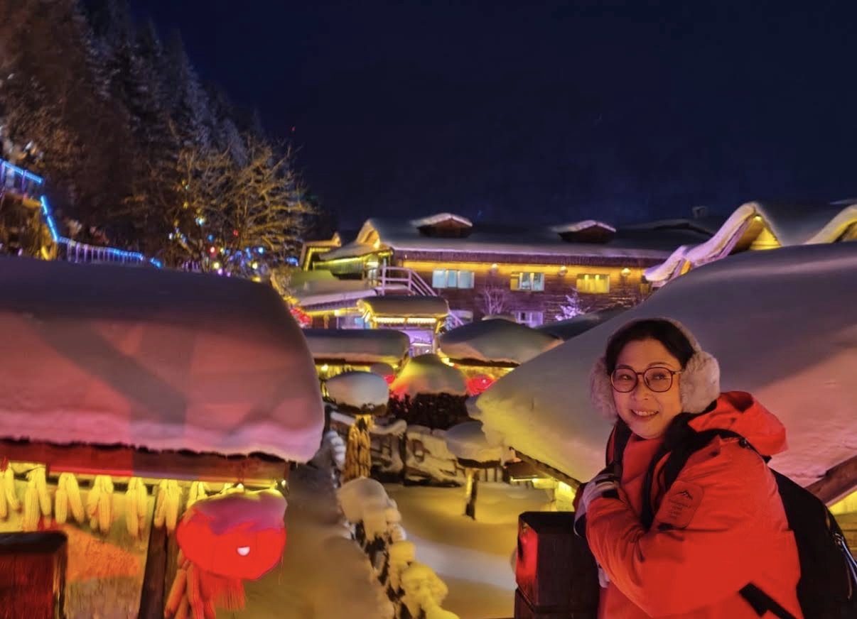 Lanterns and lights under deep rooftop snow in China Snow Town at night