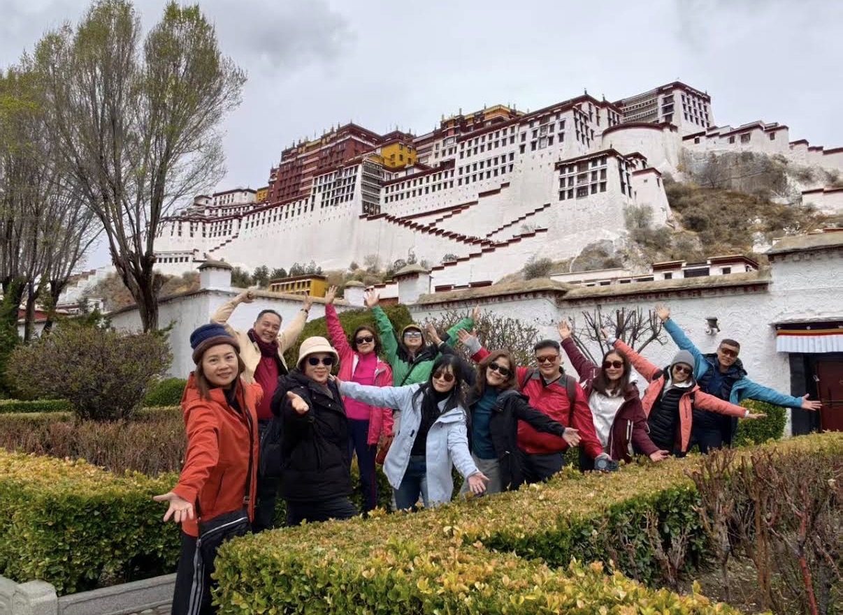 A Golden Tropics tour group in front of the Potala Palace in Lhasa