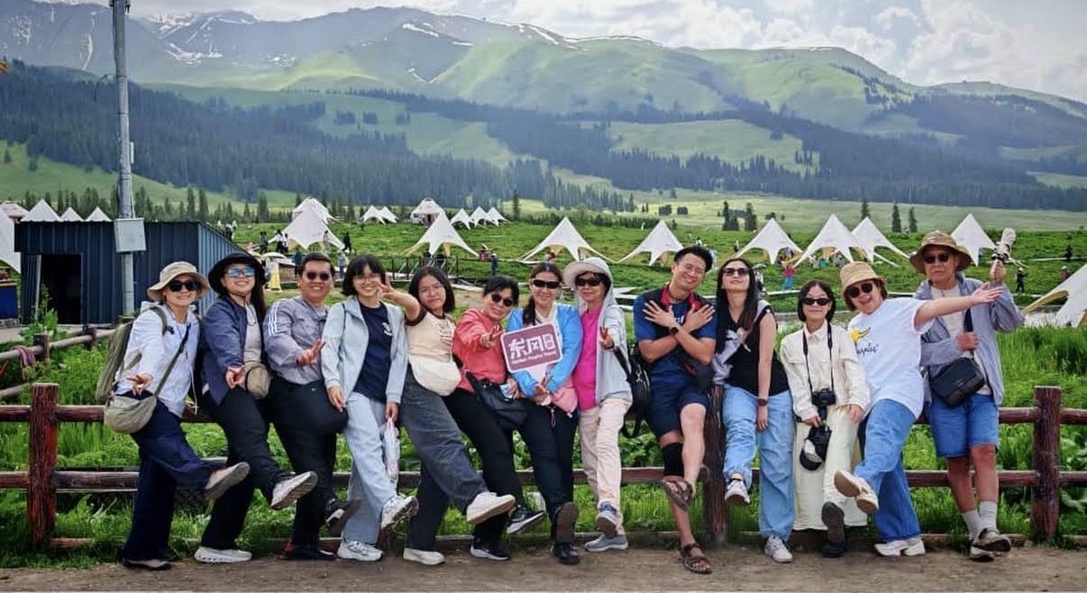 A Golden Tropics tour group on a summer grassland in Northern Xinjiang