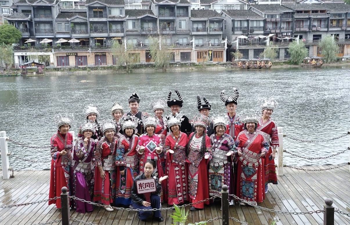 Our group dressed in Miao costumes by the river in Fenghuang Ancient Town